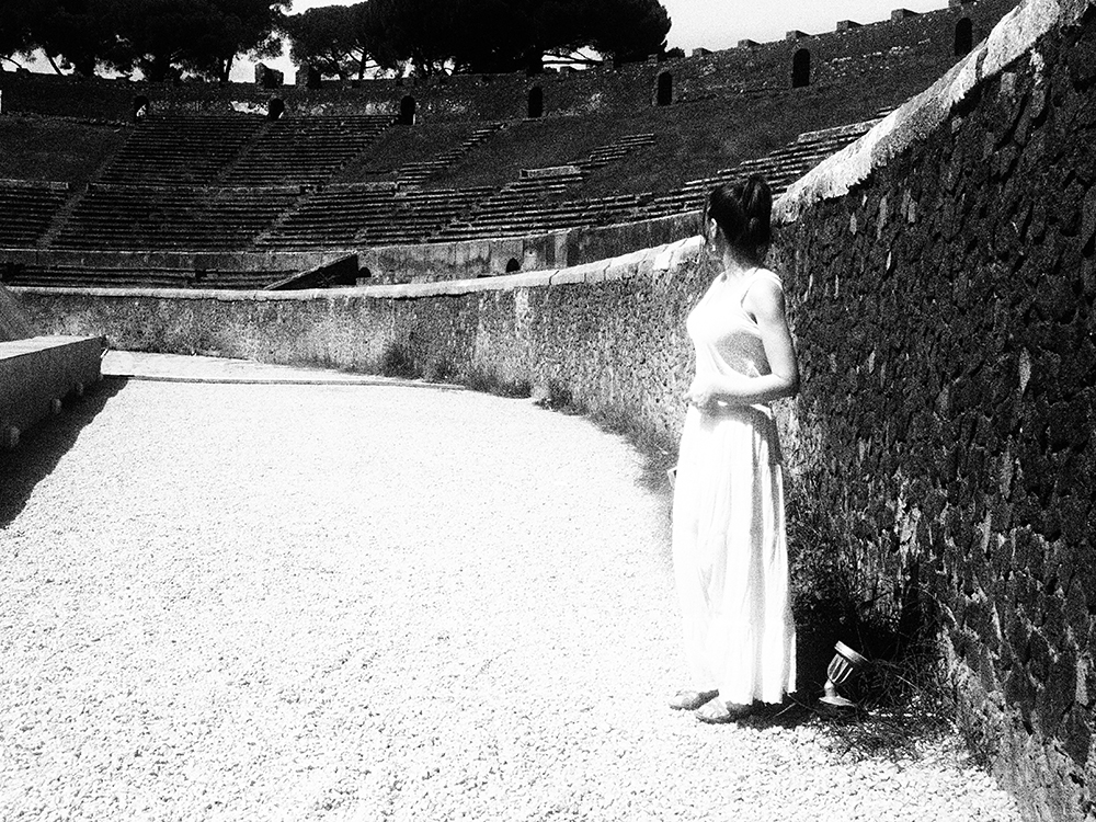 Women standing in the amphitheatre of Pompeii